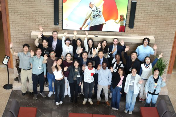 Workshop participants gathered in the Education building and waving.