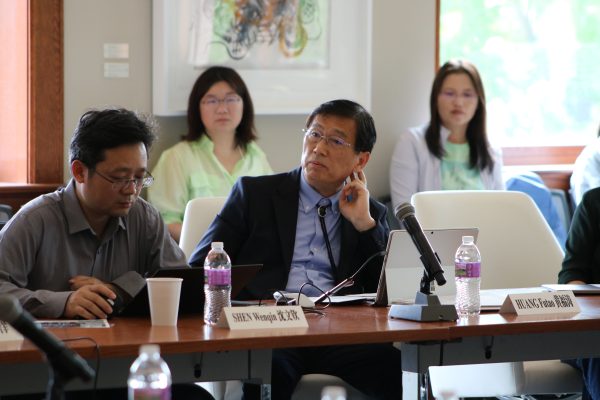 Panelists seated around a table for a workshop