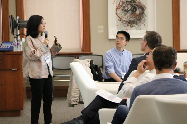 Speaker at a workshop holding a microphone.