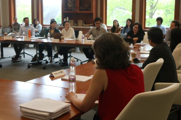Panelists around a table at a workshop.